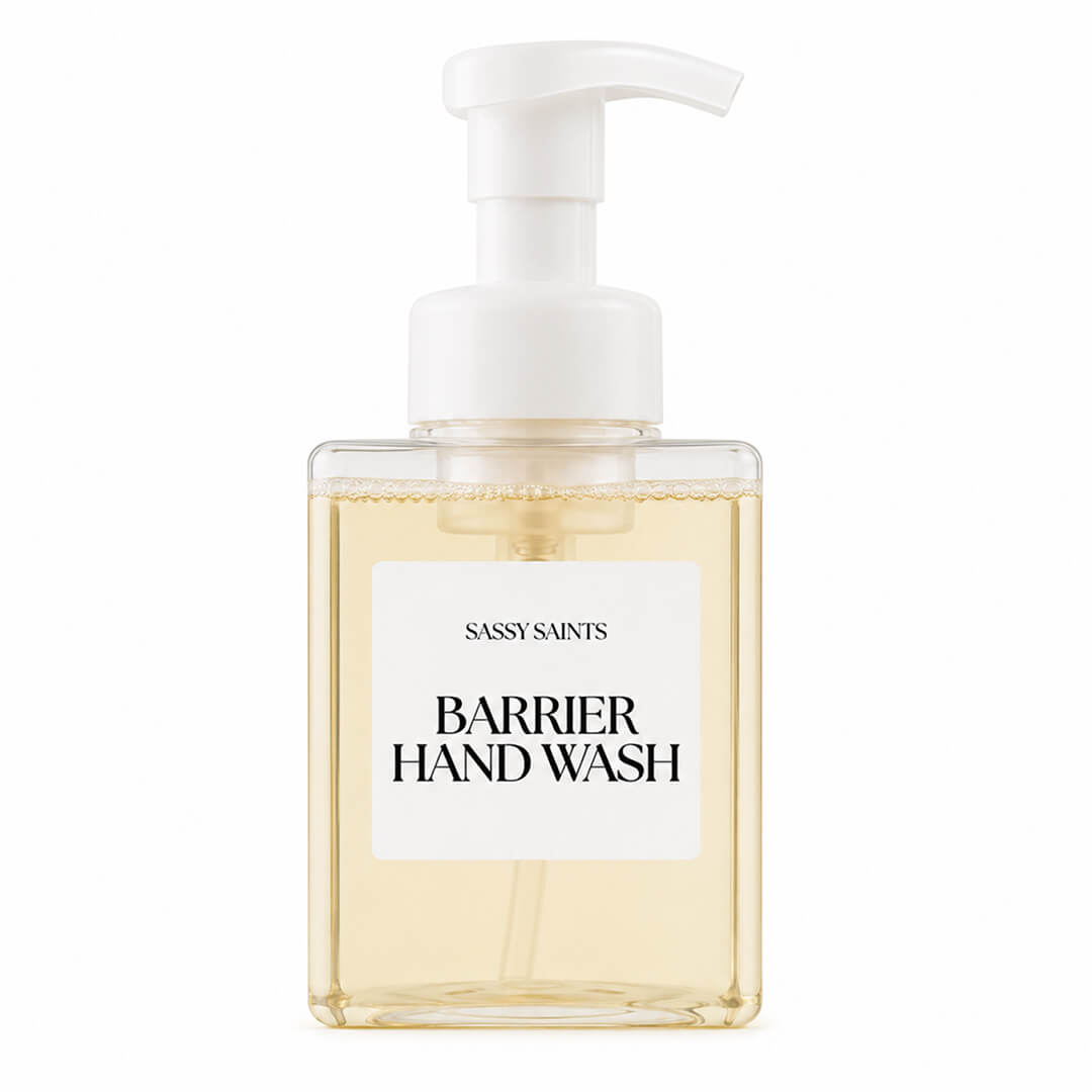 A transparent pump bottle featuring the Sassy Saints - Brings The Salon Home Barrier Hand Wash, filled with a pale yellow liquid, displayed on a plain white background.