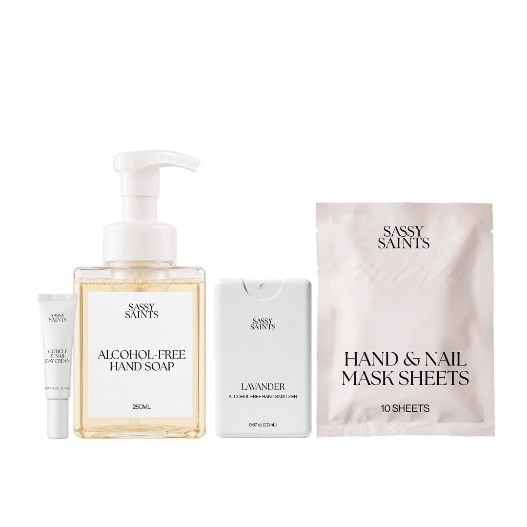 A Sassy Saints Nail Protection Bundle consisting of a tube of cuticle and nail cream, a bottle of alcohol-free hand soap, a spray bottle of hand sanitizer, and a packet of hand and nail mask sheets.