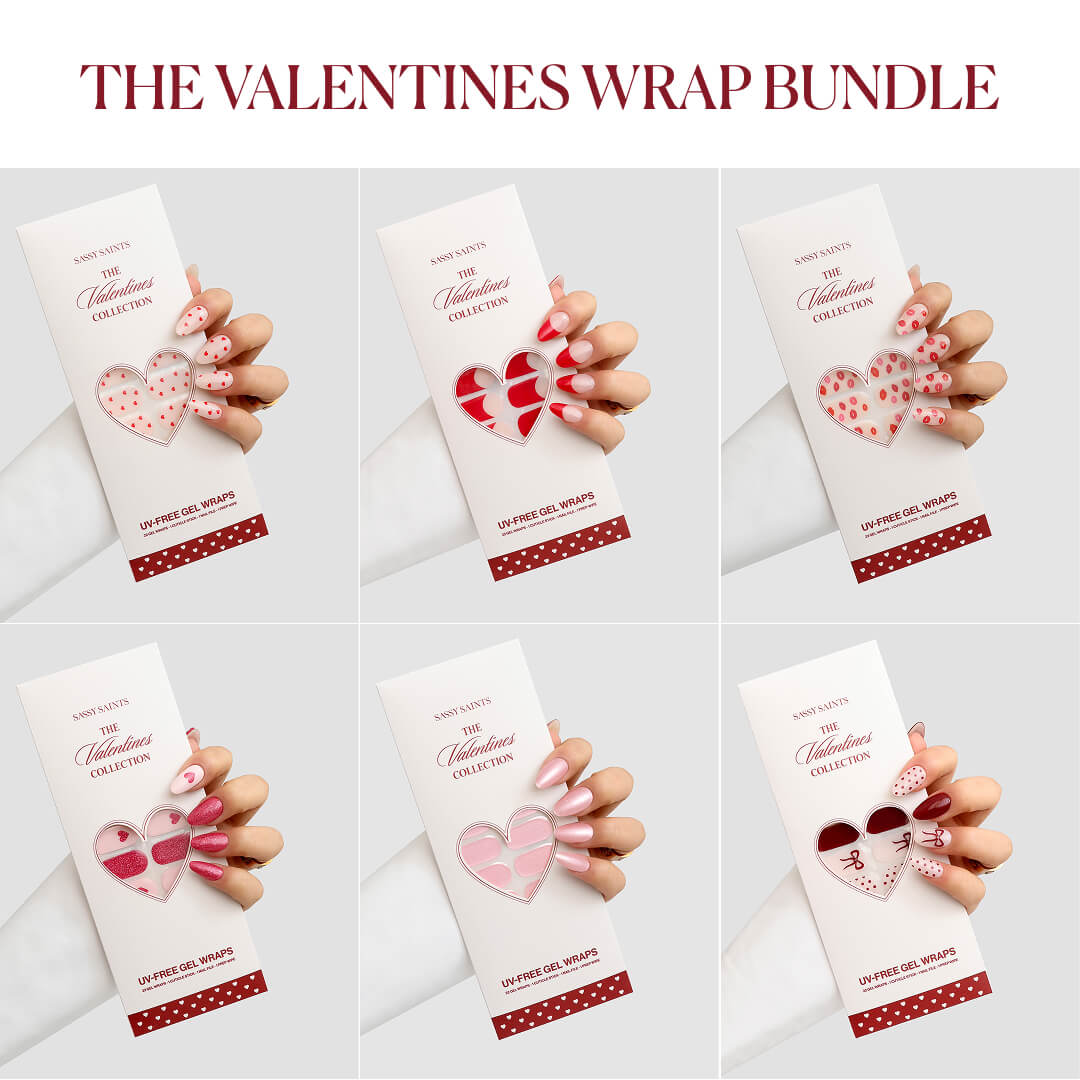 A hand displays “The Valentines Wrap Bundle (50% OFF)” by Sassy Saints - Brings The Salon Home, featuring five pink and red Valentine’s nail wrap designs in a grid, with packaging labeled “Valentine’s Collection.”.