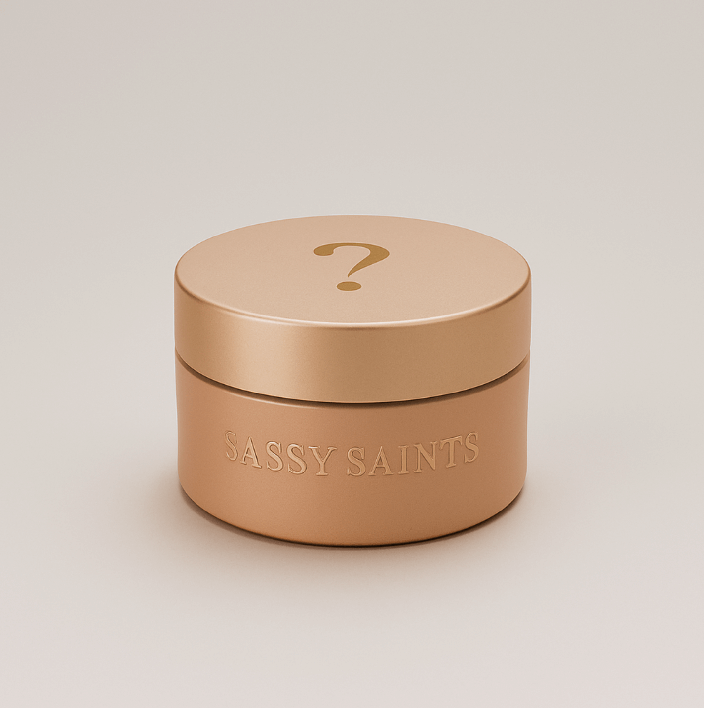 A round, rose gold cosmetic jar embossed with Sassy Saints - Brings The Salon Home and a large question mark on the lid contains the Limited Edition Dipping Powder, set against a simple, light background.