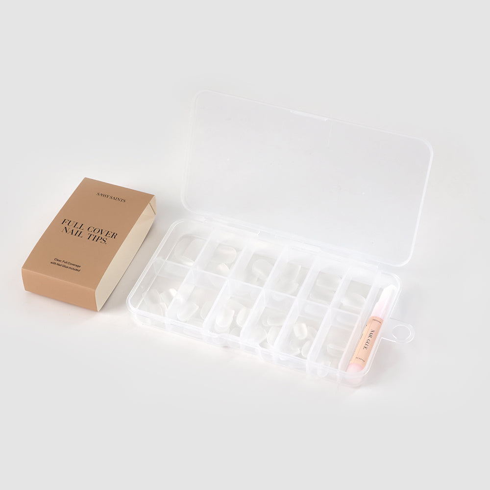 A set of Squoval Full Tips by Sassy Saints in a clear plastic compartment case, with nail glue, and a beige 'Full Cover Nail Tips' box displayed on a light background.