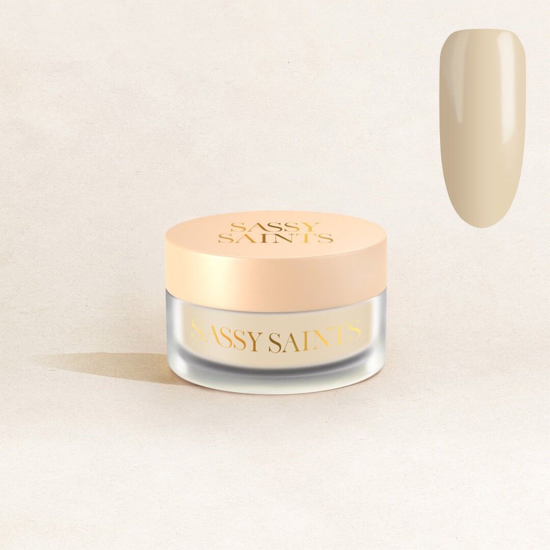 A jar of Vow Veil Dipping Powder by Sassy Saints - Brings The Salon Home sits on a light background, with a swatch above and to the right displaying its neutral beige shade.